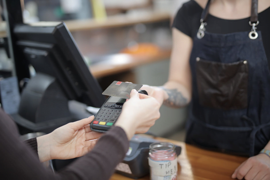 Offline event image. A customer paying for something in a store.